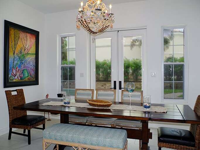 Dining table seats seven comfortably, with additional seating for 4 at the bar