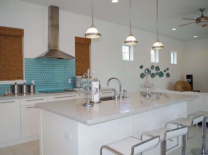 kitchen is stocked full of stainless steel appliances and has plenty of kitchen