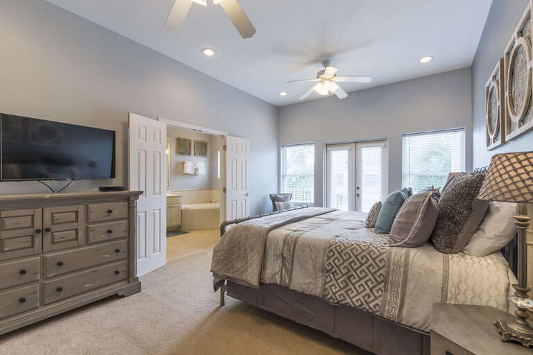 Master Suite features a roomy King size bed,  large flat screen TV,  and balcony.