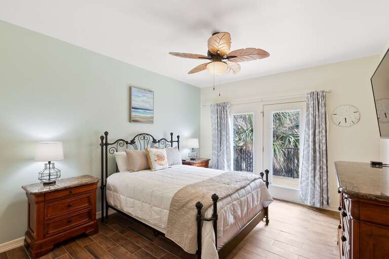 3rd guest bedroom with Queen size bed and flat screen TV, as well as balcony access.