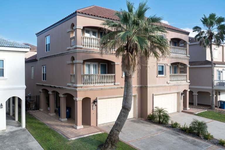Beige Building Beneath Blue Sky, Balconies Bordered By Balusters, Beside Bending Palm