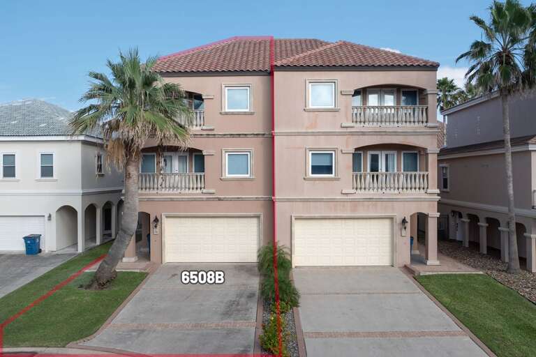 Palms Flank Pink Three-story Vacation Rental With Balcony, Twin Garages Beneath