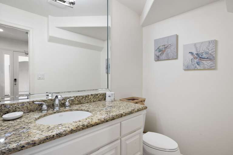 Half bathroom on first floor near the stairs.