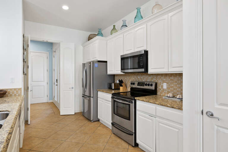 Fully equipped kitchen with stainless steel appliances.