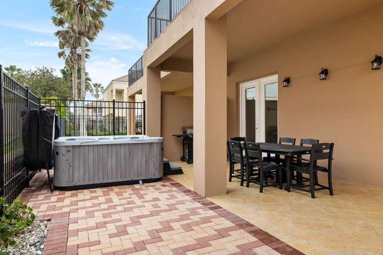 Large patio with outdoor dining table and a propane grill. NEW HOT TUB JUST INSTALLED!