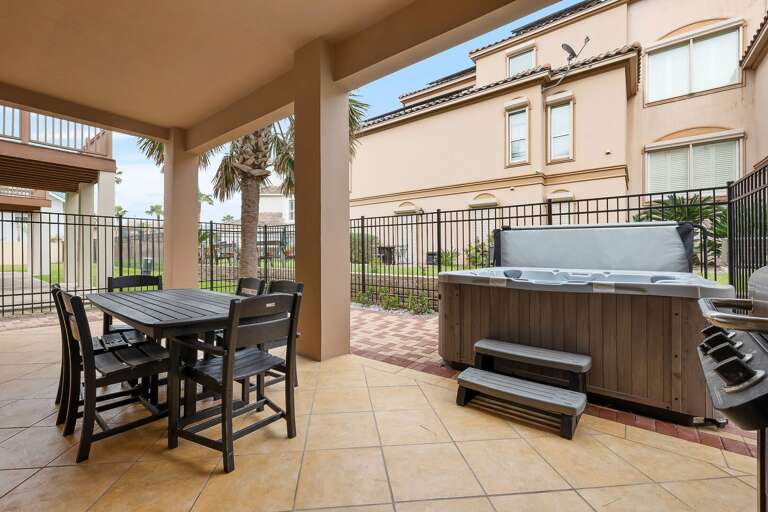 Large patio with outdoor dining table and a propane grill. NEW HOT TUB JUST INSTALLED!