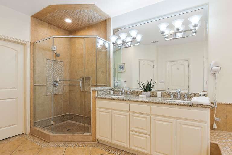 Master bathroom features a large stand-in shower and double vanity.