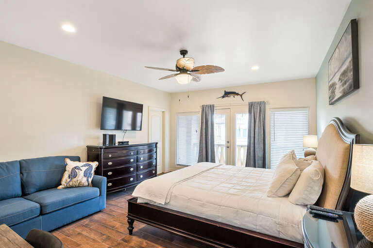 Master bedroom with King size bed, flat screen TV and private balcony.