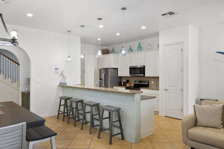 Open concept kitchen and dinning area. Dining table sits 6, additional seating at the bar for 4 guests.