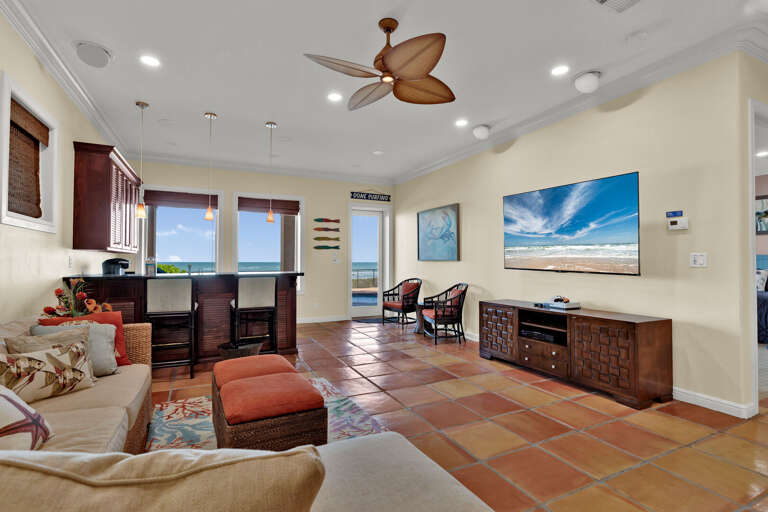 2nd living/entertainment area on the ground floor! Flat-screen TV, kitchenette with bar and entrance to the patio/pool area.