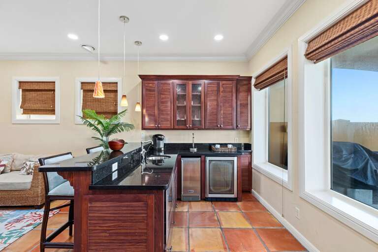 2nd living/entertainment area on the ground floor! Kitchenette/wet bar, flat-screen TV & access to the pool & patio area.