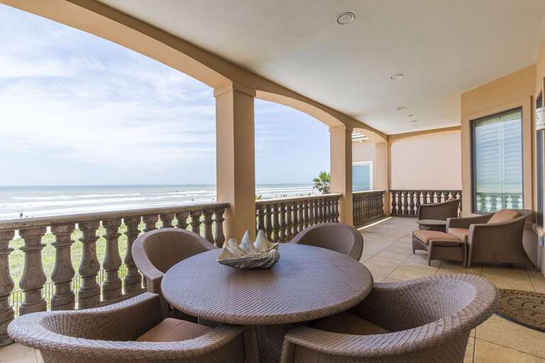 Second floor balcony with patio furniture.