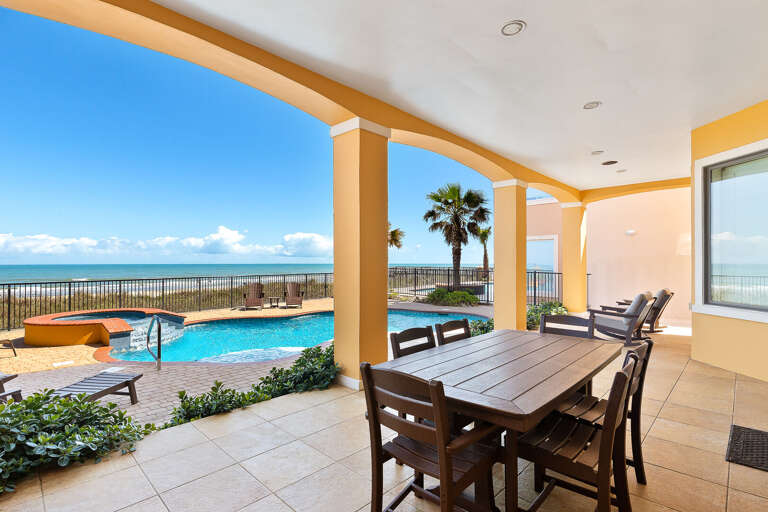 Patio area overlooking the pool and beach. (Hot tub is NOT an active amenity/it is not heated!)