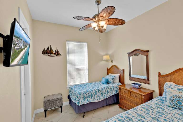 Guest bedroom with 2 twin beds, and flat screen.