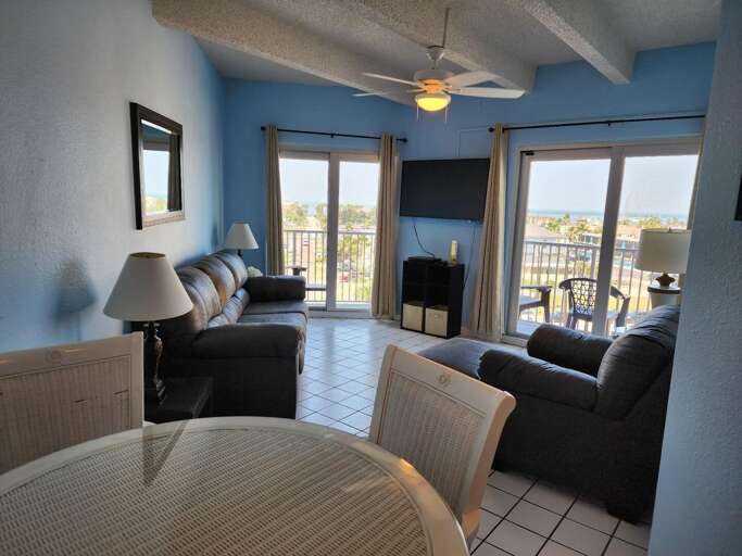 Living room area with new sofa sleeper, oversized chair & flat screen TV.