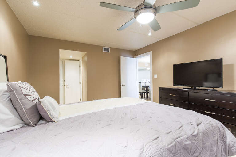 Master bedroom with a queen bed and flat screen TV Master bedroom with a queen bed and flat screen TV