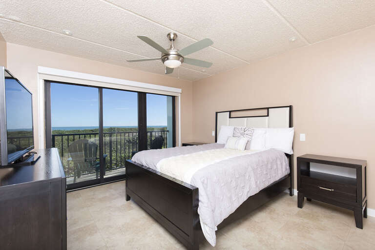 Master bedroom with a queen bed, private balcony, and flat screen TV Master bedroom with a queen bed, private balcony, and flat screen TV
