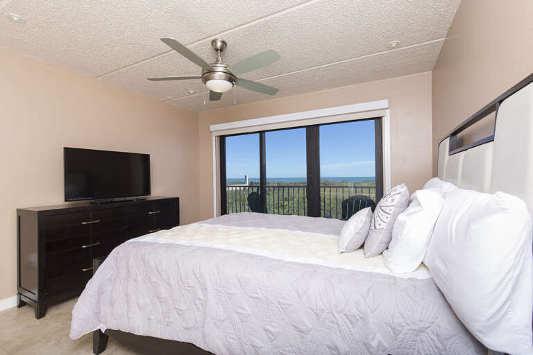 Master bedroom with a queen bed, private balcony, and flat screen TV Master bedroom with a queen bed, private balcony, and flat screen TV