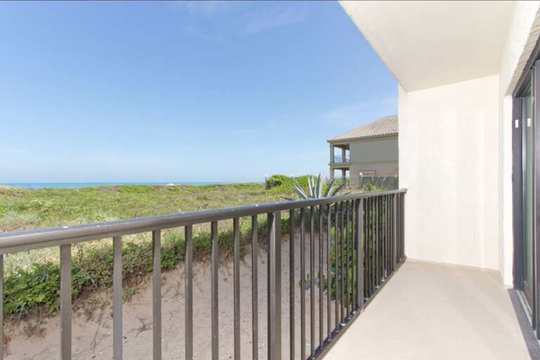 Spacious balcony with view to the beach.