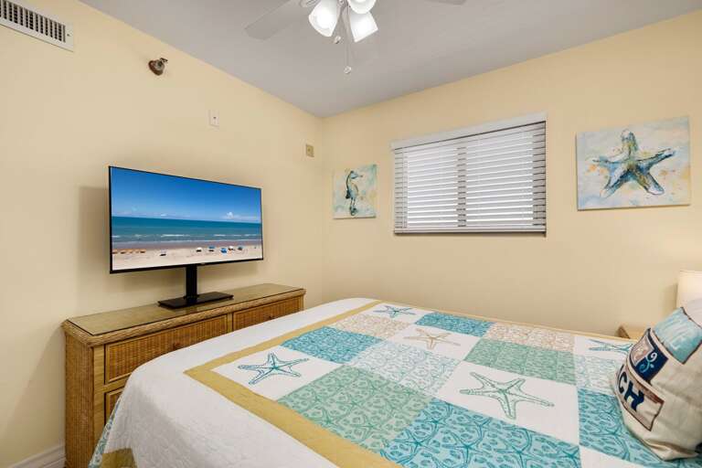 Master bedroom with a Queen size bed and flat screen TV.