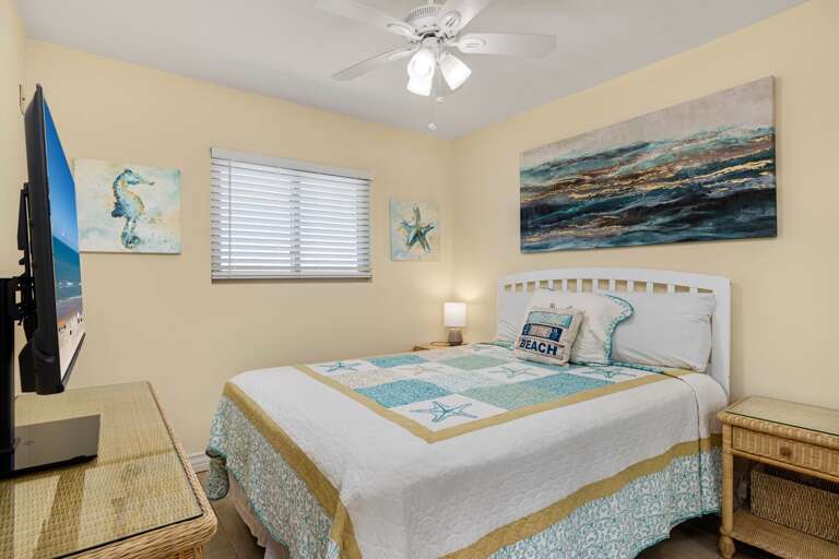 Master bedroom with a Queen size bed and flat screen TV.