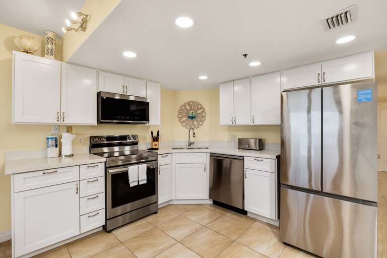 Spacious kitchen features stainless steel appliances.