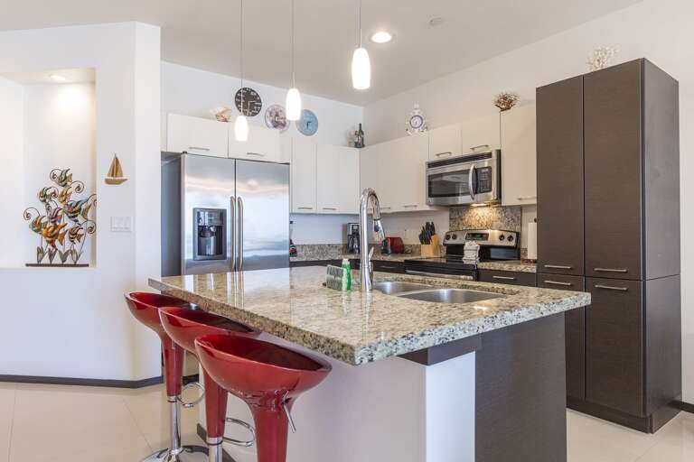 Open concept kitchen with all stainless steel appliances and oversized island. Open concept kitchen with all stainless steel appliances and oversized island.