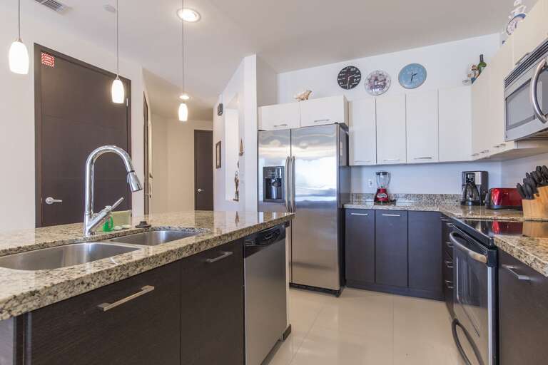 Open concept kitchen with all stainless steel appliances and oversized island.