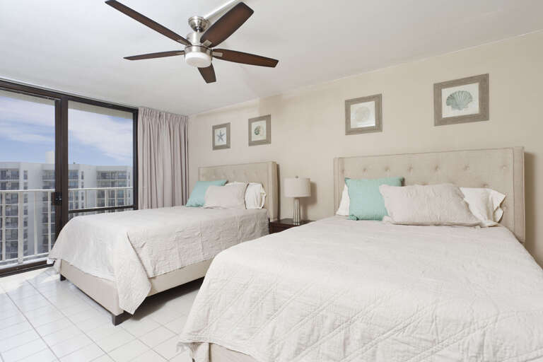 Guest bedroom with 2 queen beds with a view to the beach!