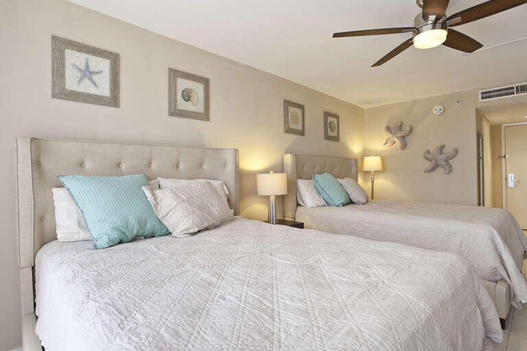 Guest bedroom with 2 queen beds with a view to the beach!