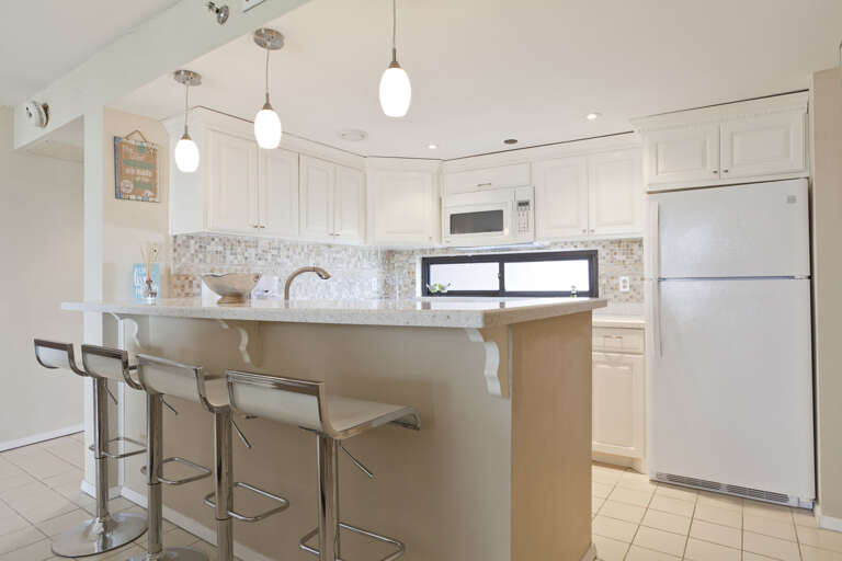 Modern kitchen fully equipped with cooking utensils and bar seating for 4 people!
