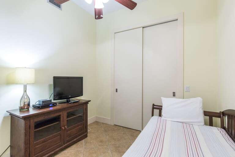 Guest bedroom equipped with flat screen TV.