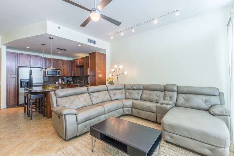 Large sectional sofa provides room for everyone in the group around a large flat screen.