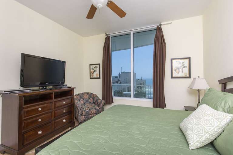 Master bedroom equipped with flat screen Tv.