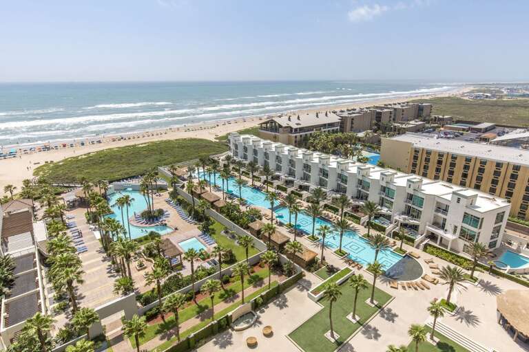 Resort pool and hot tub overlooking the beach.