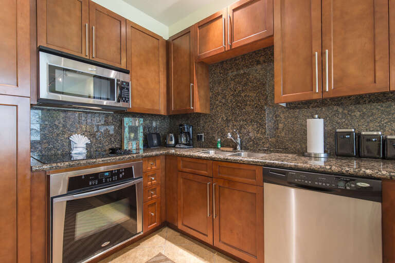 Amazing kitchen fully stocked with cooking utensils and stainless steel appliances!