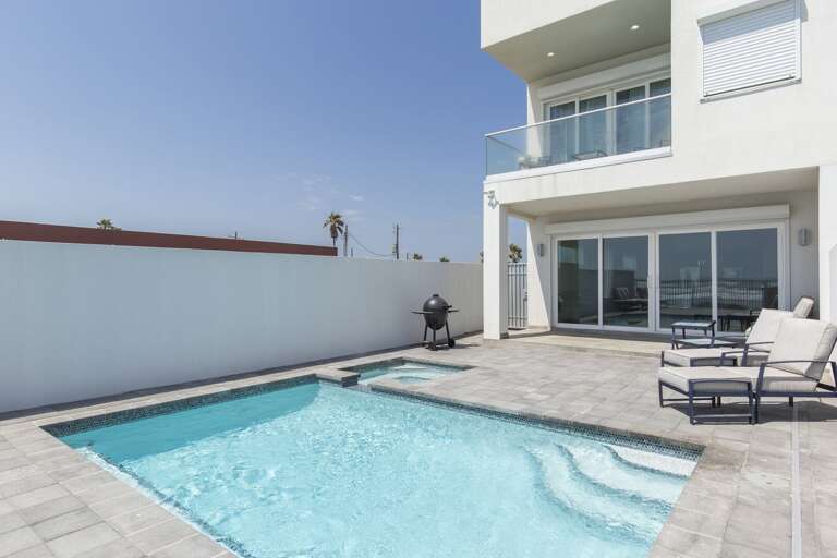 Back view of the heated pool and hot tub.