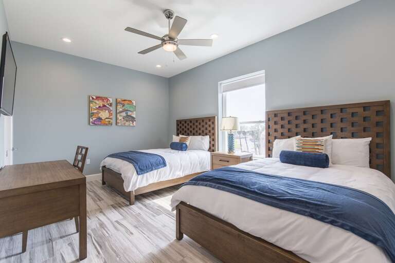 Third floor guest bedroom with two beds closest the pool