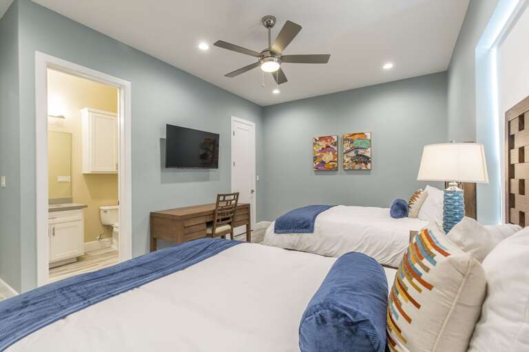 Third floor guest bedroom closest to the pool with two beds