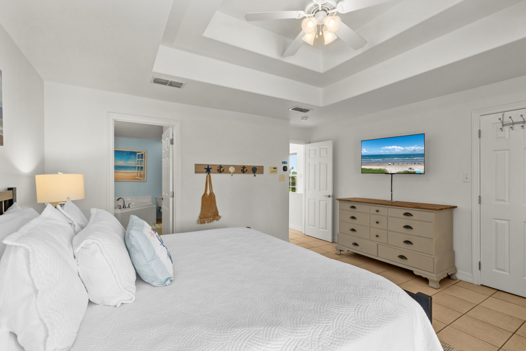 Master bedroom has a flat screen TV.