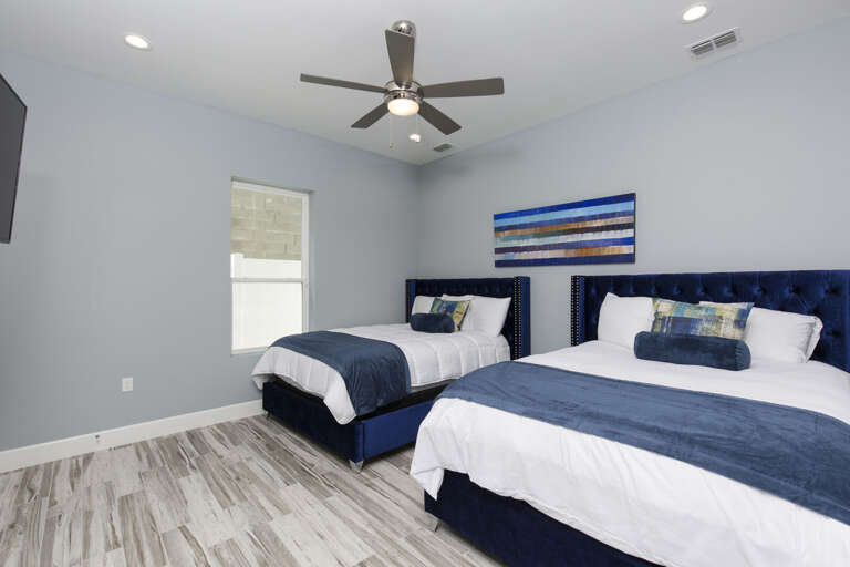 Ground floor guest bedroom with two queens