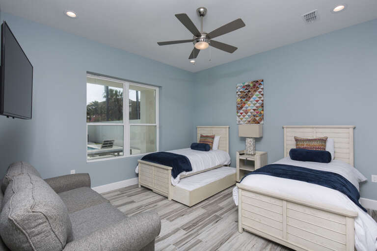 Ground floor guest bedroom with two twins featuring trundle beds