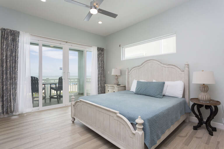 Spacious master bedroom with a king bed and balcony with oceanfront views!