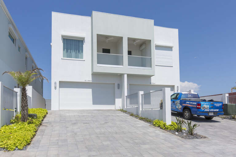 Driveway accommodates 4 compact vehicles. Additional parking on Gulf Blvd. (Garage is not available for guest use).