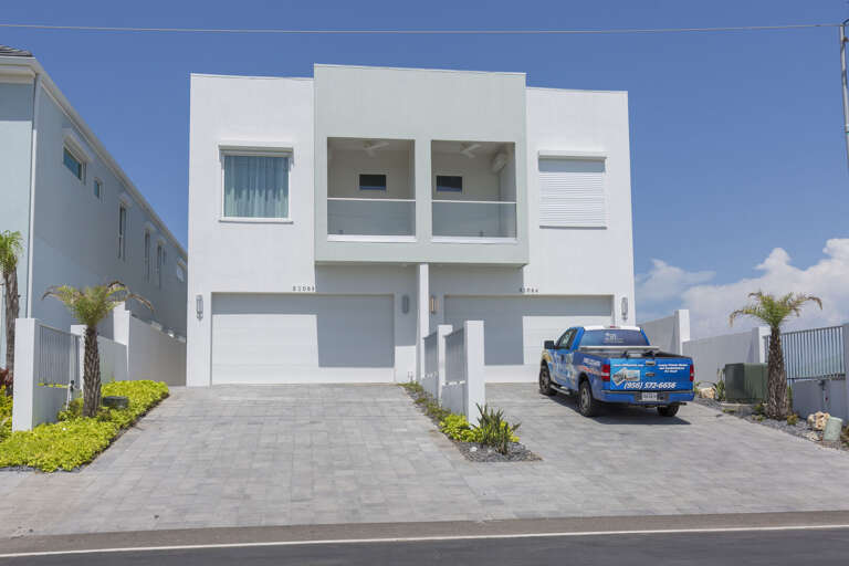 Driveway accommodates 4 compact vehicles. Additional parking on Gulf Blvd. (Garage is not available for guest use).