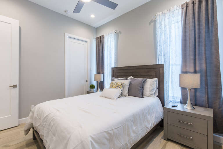 Second floor guest bedroom with a queen bed