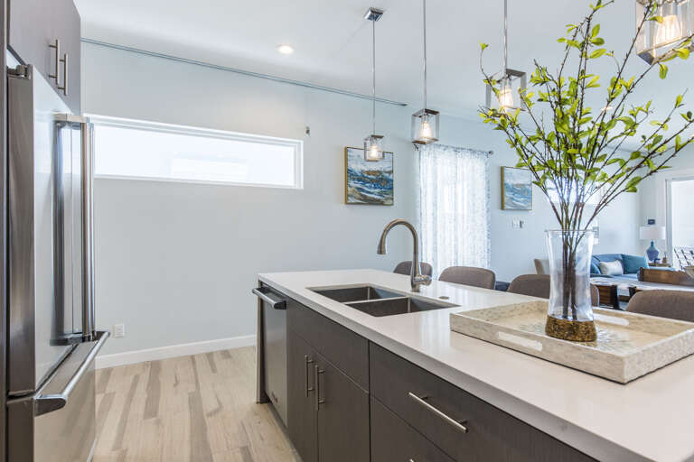 Fully stocked kitchen equipped with stainless steel appliances and a large center island.