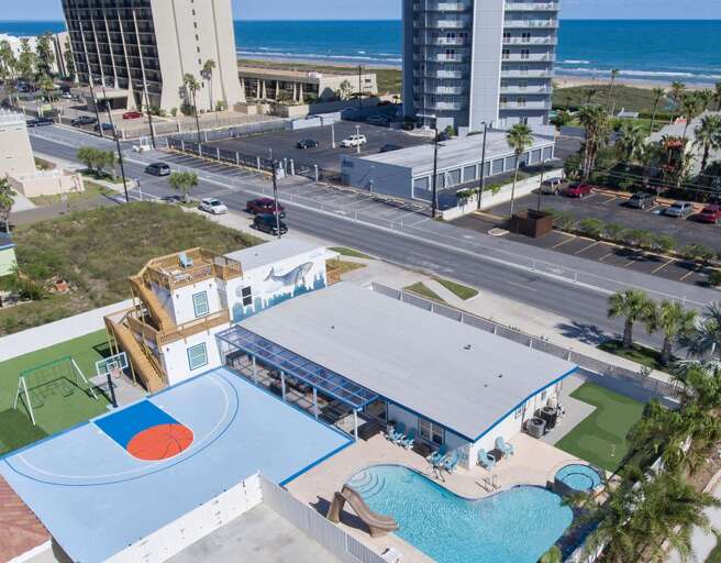 Aerial view of the basketball court, pool, putting green, beautiful home and beach!