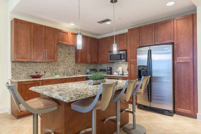 Amazing kitchen fully stocked with cooking utensils and stainless steel appliances!