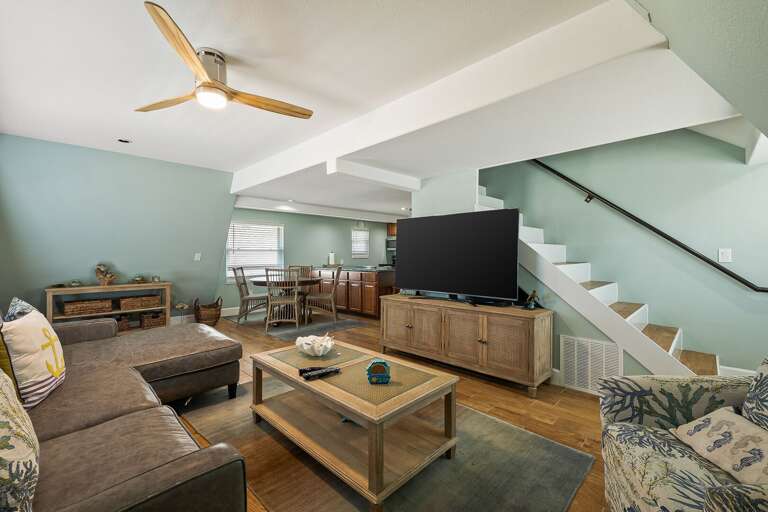 Living are with staircase leading to 3rd floor bedroom